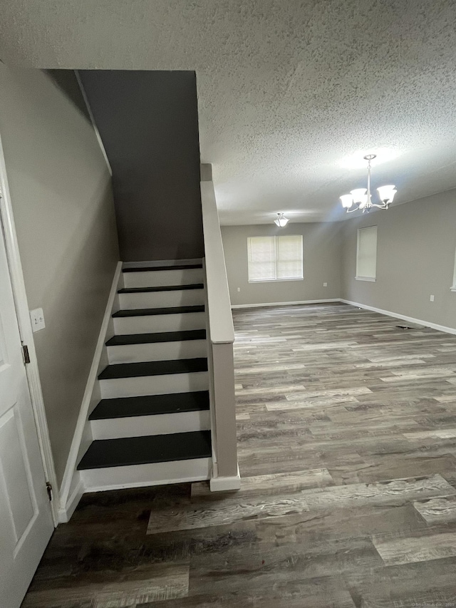20 Cossett St, Waterbury, CT 06704 - staircase with a textured ceiling, a chandelier, and wood finished floors