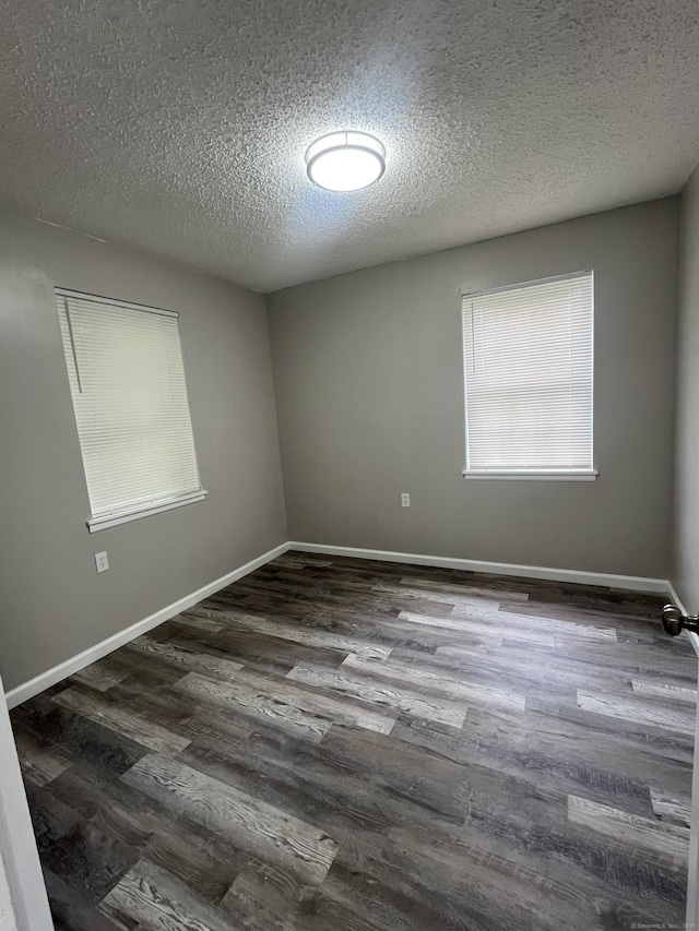 20 Cossett St, Waterbury, CT 06704 - unfurnished room with a textured ceiling and dark wood finished floors