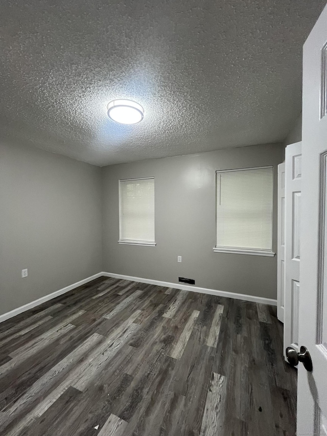 20 Cossett St, Waterbury, CT 06704 - spare room featuring a textured ceiling and dark wood-type flooring