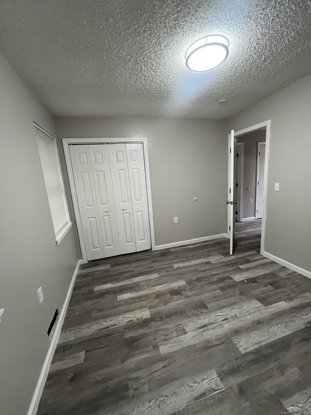 20 Cossett St, Waterbury, CT 06704 - unfurnished bedroom featuring wood finished floors, a textured ceiling, and a closet