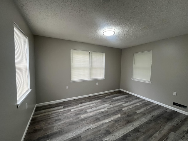 20 Cossett St, Waterbury, CT 06704 - empty room with a textured ceiling and dark wood finished floors