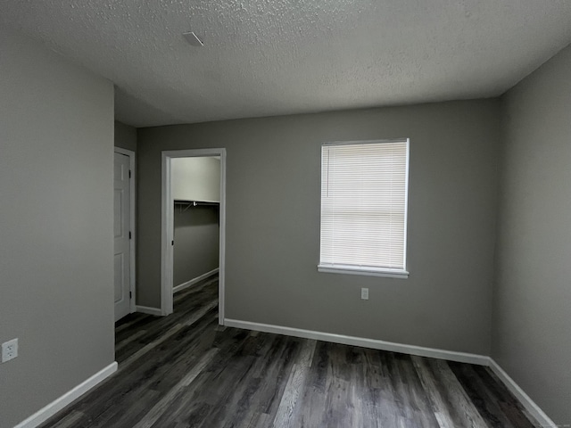 20 Cossett St, Waterbury, CT 06704 - unfurnished bedroom featuring dark wood-type flooring, a textured ceiling, and a closet