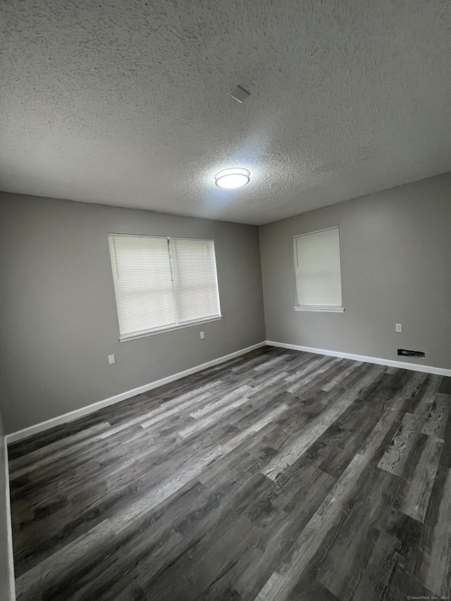 20 Cossett St, Waterbury, CT 06704 - unfurnished room with dark wood-type flooring and a textured ceiling