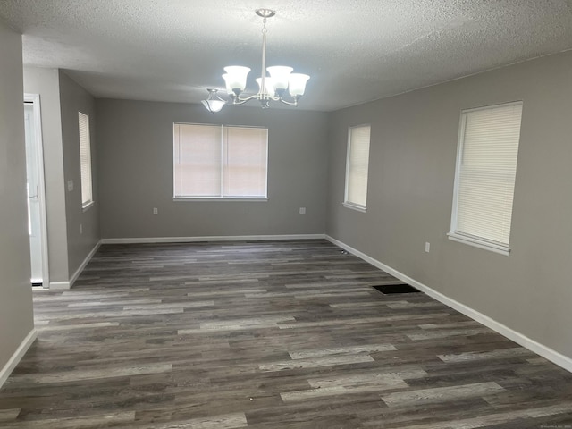 20 Cossett St, Waterbury, CT 06704 - spare room featuring a chandelier, dark wood-type flooring, and a textured ceiling