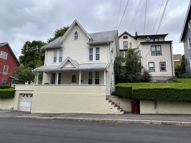 48 Anderson St, Naugatuck, CT 06770 - view of front of house with a porch, a garage, and stairs