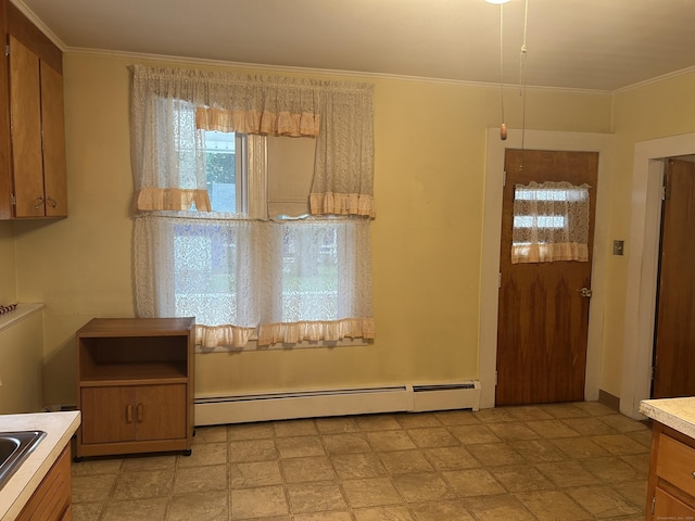 48 Anderson St, Naugatuck, CT 06770 - unfurnished dining area with a baseboard heating unit, crown molding, and a sink