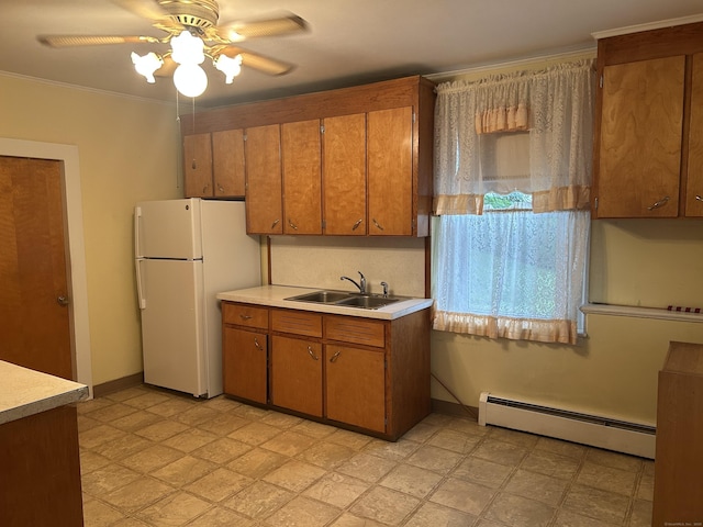 48 Anderson St, Naugatuck, CT 06770 - kitchen featuring baseboard heating, a sink, freestanding refrigerator, brown cabinetry, and light countertops