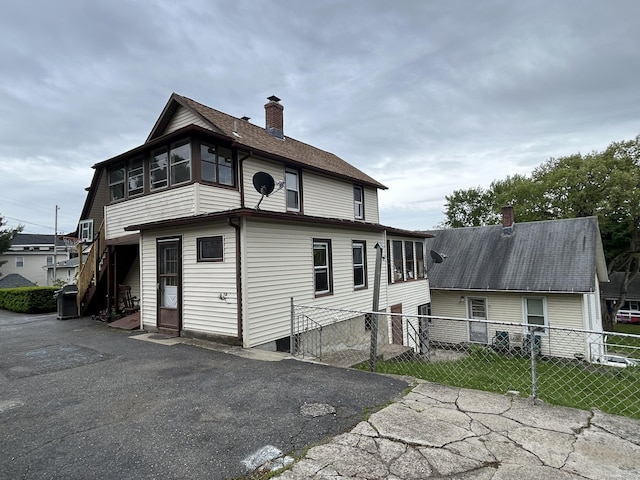 48 Anderson St, Naugatuck, CT 06770 - rear view of property featuring a chimney
