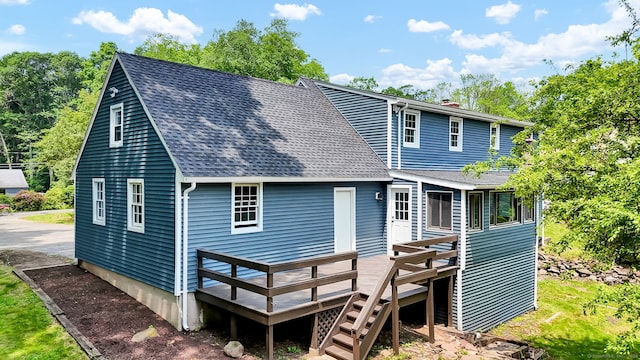 890 Copper Hill Rd, Suffield, CT 06093 - rear view of property featuring roof with shingles, a deck, a chimney, and stairway