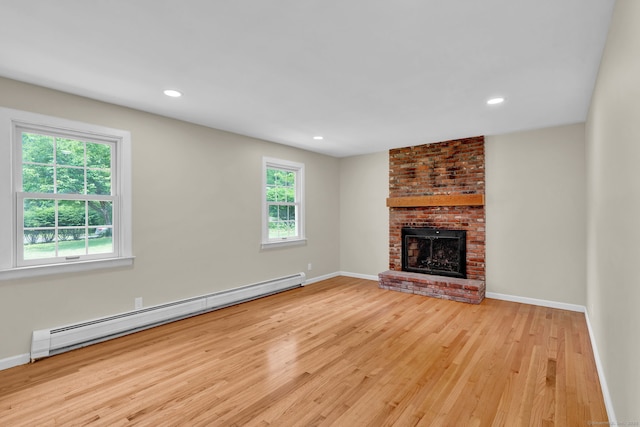 890 Copper Hill Rd, Suffield, CT 06093 - unfurnished living room featuring baseboard heating, wood finished floors, a brick fireplace, and recessed lighting