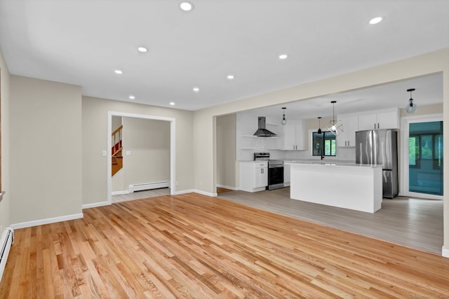 890 Copper Hill Rd, Suffield, CT 06093 - unfurnished living room with a baseboard heating unit, light wood-type flooring, recessed lighting, and stairway