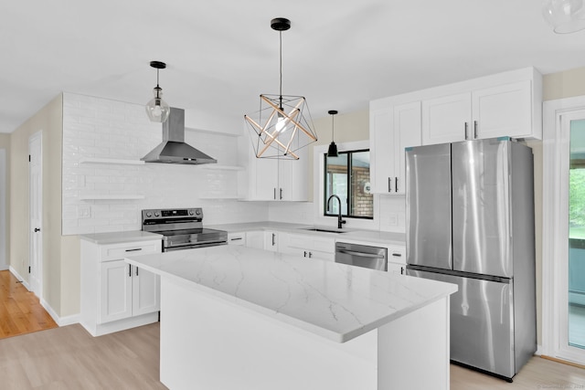 890 Copper Hill Rd, Suffield, CT 06093 - kitchen featuring appliances with stainless steel finishes, wall chimney exhaust hood, light wood finished floors, a kitchen island, and a chandelier