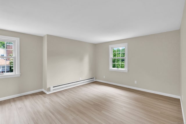 890 Copper Hill Rd, Suffield, CT 06093 - empty room featuring a baseboard radiator, plenty of natural light, and light wood-style flooring