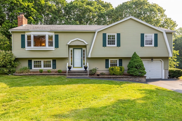10 Longview Ln, Wallingford, CT 06492 - bi-level home with asphalt driveway, a garage, a chimney, and a front lawn