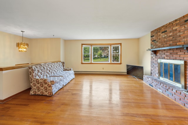 10 Longview Ln, Wallingford, CT 06492 - living area featuring a chandelier, wood finished floors, baseboards, and a fireplace
