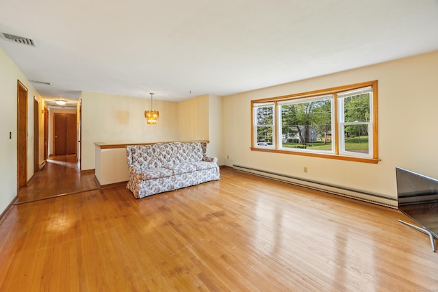 10 Longview Ln, Wallingford, CT 06492 - unfurnished room featuring a baseboard heating unit, a chandelier, and light wood-style flooring