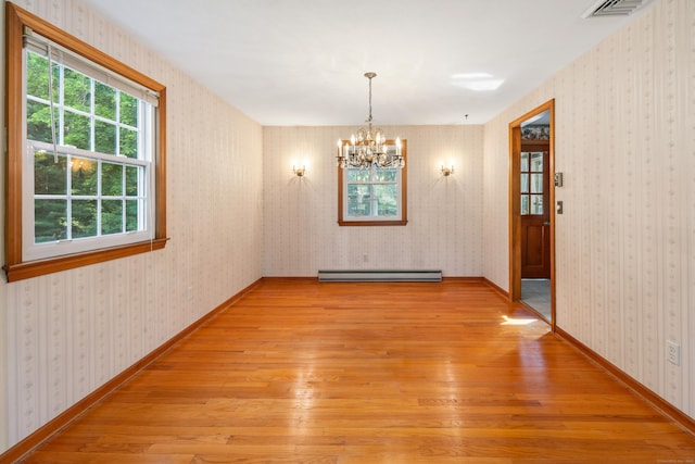10 Longview Ln, Wallingford, CT 06492 - unfurnished dining area with light wood-style floors, baseboard heating, a chandelier, and baseboards