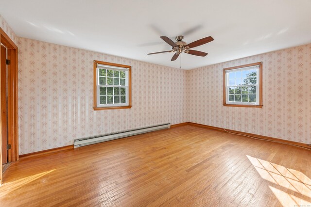 10 Longview Ln, Wallingford, CT 06492 - unfurnished room with a baseboard heating unit, plenty of natural light, hardwood / wood-style flooring, and ceiling fan