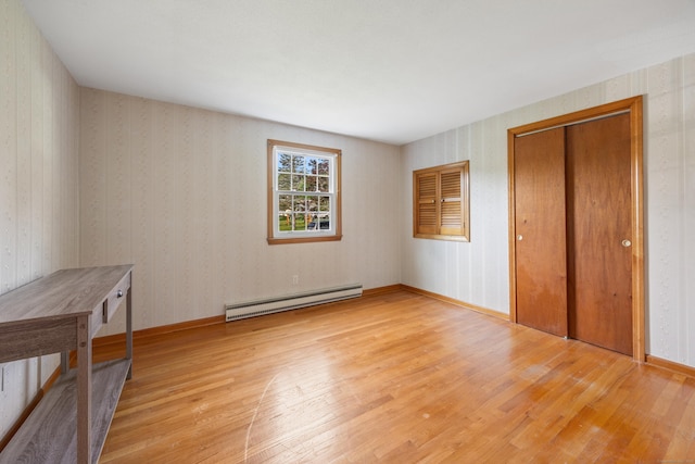10 Longview Ln, Wallingford, CT 06492 - unfurnished bedroom featuring baseboard heating, light wood finished floors, a closet, and wallpapered walls
