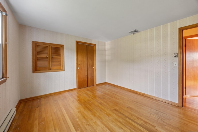 10 Longview Ln, Wallingford, CT 06492 - empty room featuring baseboard heating, hardwood / wood-style flooring, and wallpapered walls