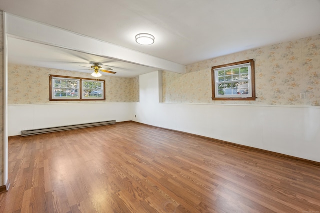 10 Longview Ln, Wallingford, CT 06492 - unfurnished room featuring baseboard heating, wallpapered walls, a wainscoted wall, wood finished floors, and a ceiling fan