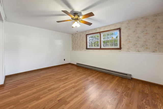 10 Longview Ln, Wallingford, CT 06492 - unfurnished room with a baseboard heating unit, wainscoting, wallpapered walls, ceiling fan, and wood finished floors