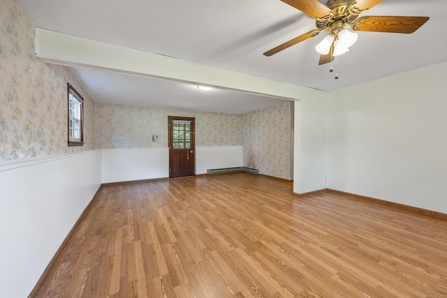 10 Longview Ln, Wallingford, CT 06492 - unfurnished room featuring wallpapered walls, a baseboard radiator, light wood-style flooring, wainscoting, and a ceiling fan