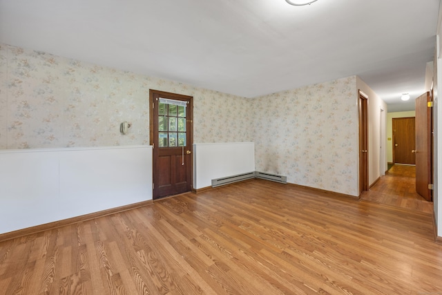10 Longview Ln, Wallingford, CT 06492 - spare room featuring light wood-style flooring, wainscoting, a baseboard radiator, and wallpapered walls