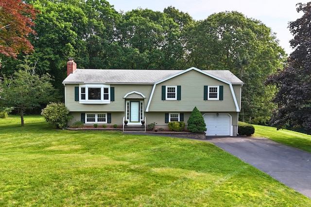 10 Longview Ln, Wallingford, CT 06492 - raised ranch with asphalt driveway, a garage, a chimney, a front yard, and roof with shingles