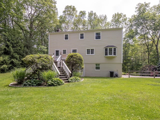 10 Old Kings Hwy, Wilton, CT 06897 - rear view of house featuring stairs, a lawn, a wooden deck, a chimney, and view of scattered trees