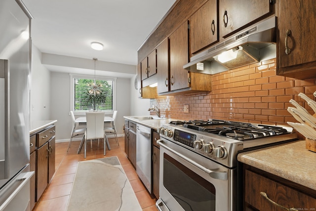 646 Onondaga Ln Unit B, Stratford, CT 06614 - kitchen with stainless steel appliances, under cabinet range hood, tasteful backsplash, a sink, and light tile patterned flooring