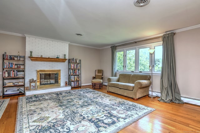 17 Farmstead Ln, West Hartford, CT 06117 - living room featuring a baseboard heating unit, wood finished floors, a brick fireplace, and ornamental molding