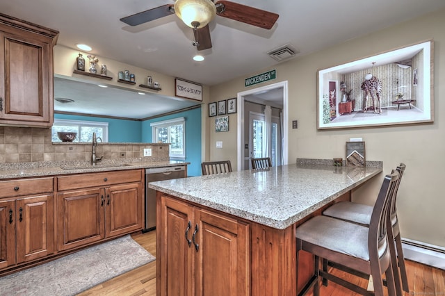17 Farmstead Ln, West Hartford, CT 06117 - kitchen featuring dishwasher, a peninsula, a sink, light wood-style flooring, and recessed lighting