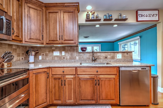 17 Farmstead Ln, West Hartford, CT 06117 - kitchen with appliances with stainless steel finishes, a sink, brown cabinetry, and tasteful backsplash