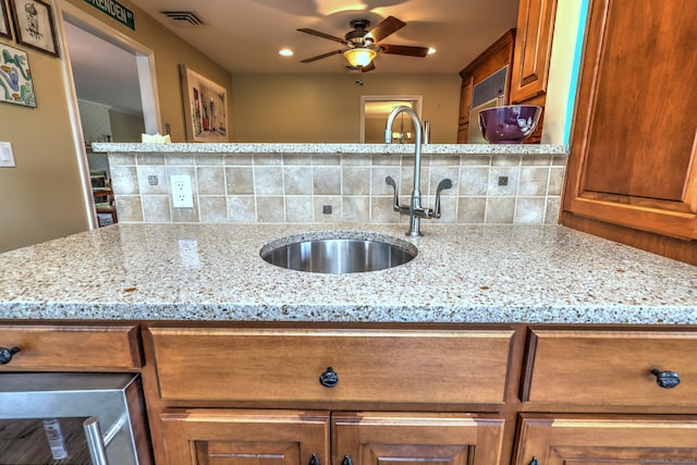 17 Farmstead Ln, West Hartford, CT 06117 - kitchen with a sink, brown cabinetry, decorative backsplash, and a ceiling fan