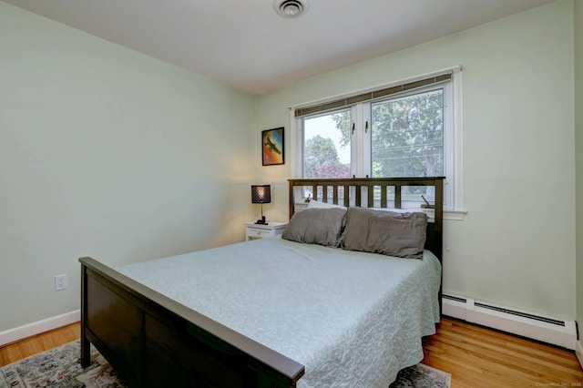 17 Farmstead Ln, West Hartford, CT 06117 - bedroom featuring a baseboard heating unit, light wood-type flooring, and baseboards