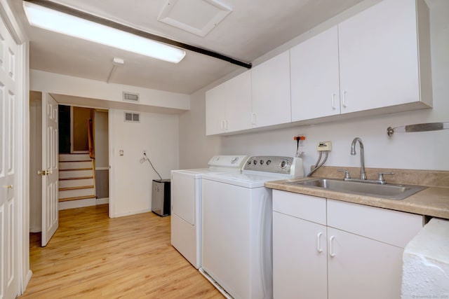 17 Farmstead Ln, West Hartford, CT 06117 - laundry room with washing machine and dryer, cabinet space, light wood-style floors, and baseboards
