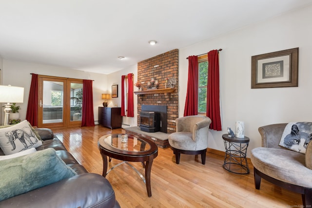 43 Debi Cir, Colchester, CT 06415 - living area with healthy amount of natural light, light wood-type flooring, a wood stove, and a baseboard heating unit