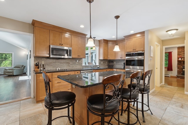 43 Debi Cir, Colchester, CT 06415 - kitchen with stainless steel microwave, a sink, decorative backsplash, a breakfast bar area, and a baseboard heating unit