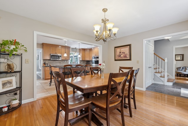 43 Debi Cir, Colchester, CT 06415 - dining room featuring stairway, light wood-style flooring, a chandelier, and baseboards