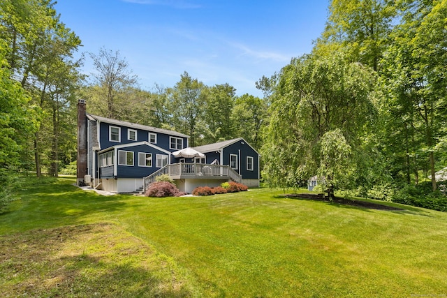 43 Debi Cir, Colchester, CT 06415 - rear view of property featuring a chimney, a deck, a yard, and stairs