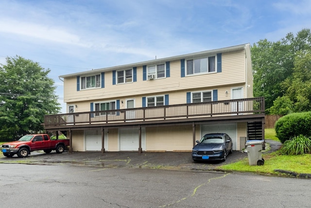 39 Mechanic St, Bristol, CT 06010 - townhome / multi-family property featuring a wooden deck, an attached garage, and driveway