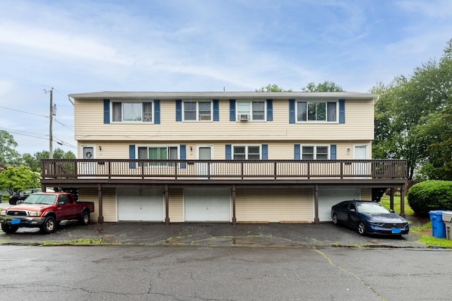 39 Mechanic St, Bristol, CT 06010 - view of front facade with an attached garage, driveway, and a wooden deck