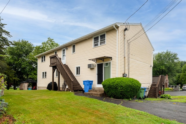 39 Mechanic St, Bristol, CT 06010 - rear view of house with stairs, a yard, and a wall mounted AC