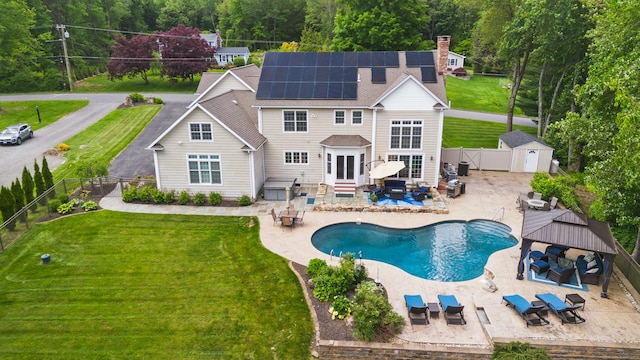 11 Delno Dr, Danbury, CT 06811 - back of property with solar panels, a patio, a chimney, outdoor dining space, and entry steps