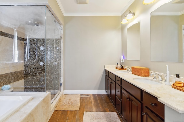 11 Delno Dr, Danbury, CT 06811 - bathroom featuring double vanity, a garden tub, a stall shower, baseboards, and wood finished floors