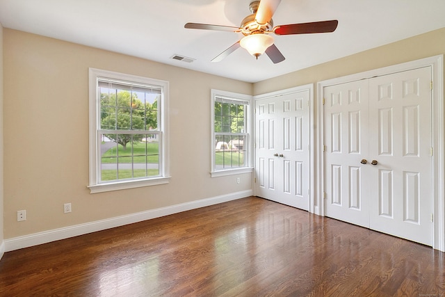 11 Delno Dr, Danbury, CT 06811 - unfurnished bedroom with multiple closets, baseboards, wood finished floors, and ceiling fan