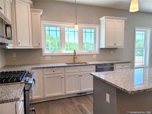 22 Lombard Cir Unit 22, North Haven, CT 06473 - kitchen with stainless steel appliances, plenty of natural light, white cabinetry, and wood finished floors