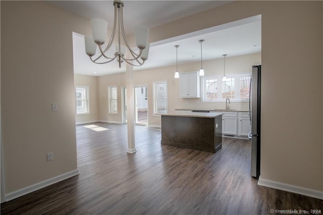 22 Lombard Cir Unit 22, North Haven, CT 06473 - kitchen featuring a kitchen island, white cabinets, dark wood-style floors, open floor plan, and backsplash