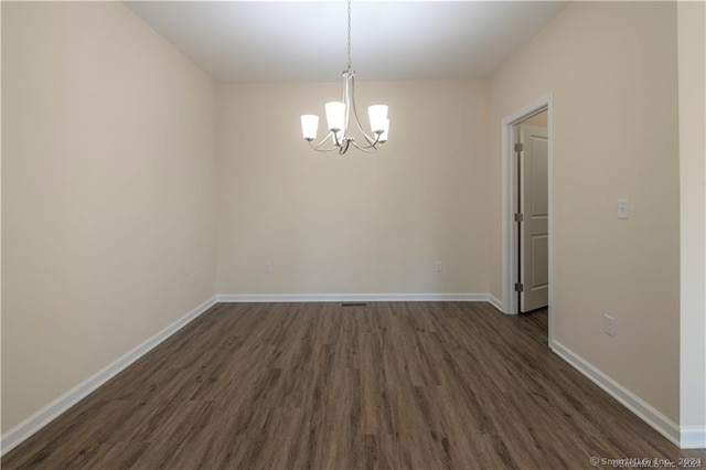 22 Lombard Cir Unit 22, North Haven, CT 06473 - spare room with a chandelier and dark wood finished floors